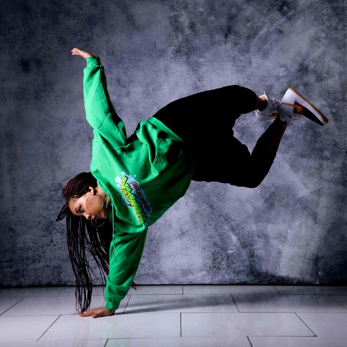 Actress, choreographer and dancer Ariyan Johnson kicks up her feet and balances on one arm.