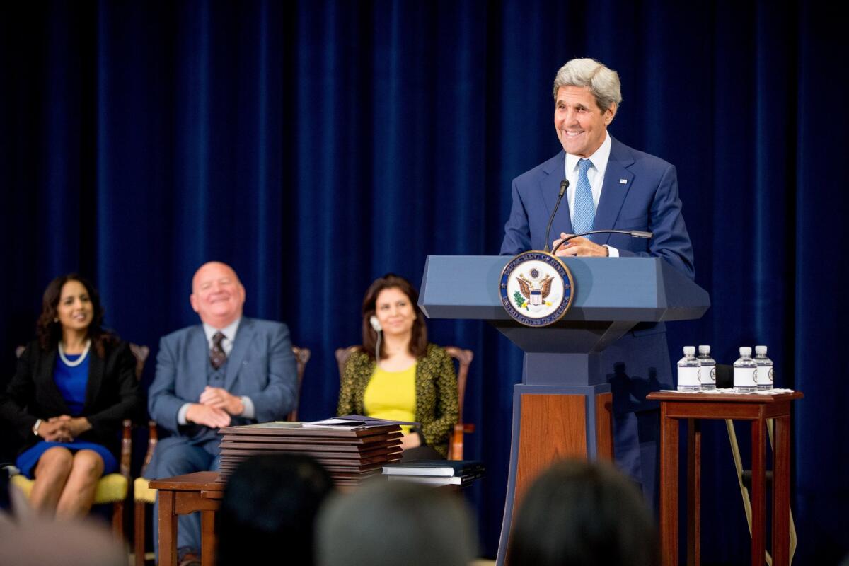 Secretary of State John Kerry, accompanied by "2015 Trafficking in Persons Report heroes,” whose efforts have made an impact on the global fight against modern slavery, speaks during a news conference at the State Department on July 27.