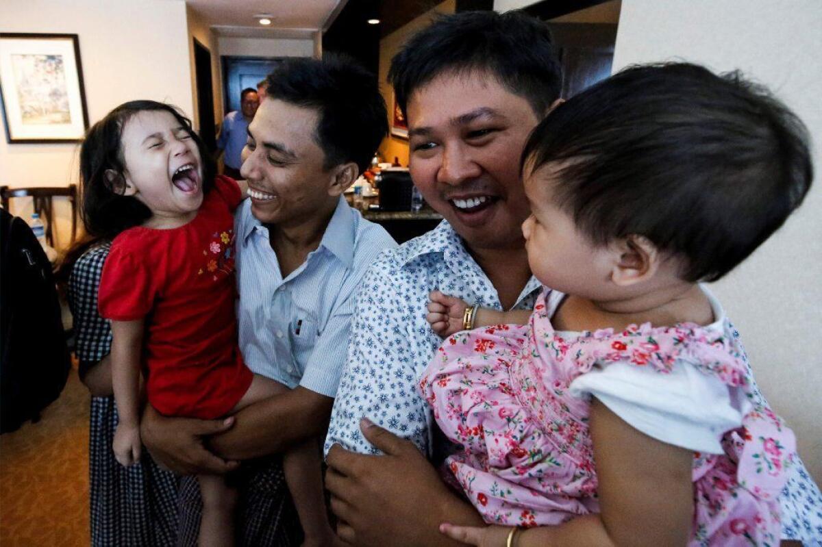 Reuters journalists Wa Lone, right, and Kyaw Soe Oo celebrate with their daughters after being freed from prison May 7 in Myanmar.