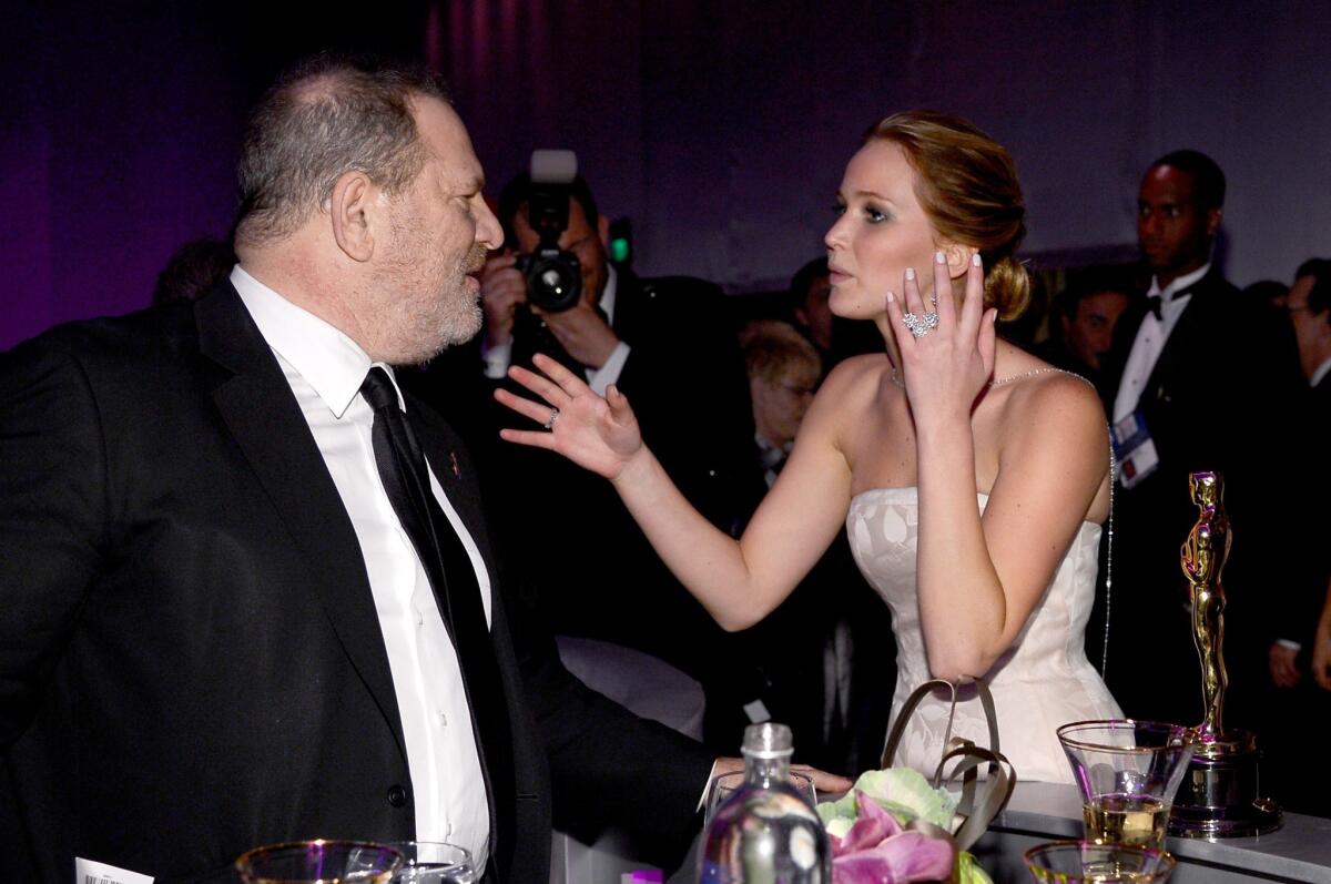 "Silver Linings Playbook" producer Harvey Weinstein talks with Oscar winner Jennifer Lawrence at the 2013 Oscars Governors Ball.