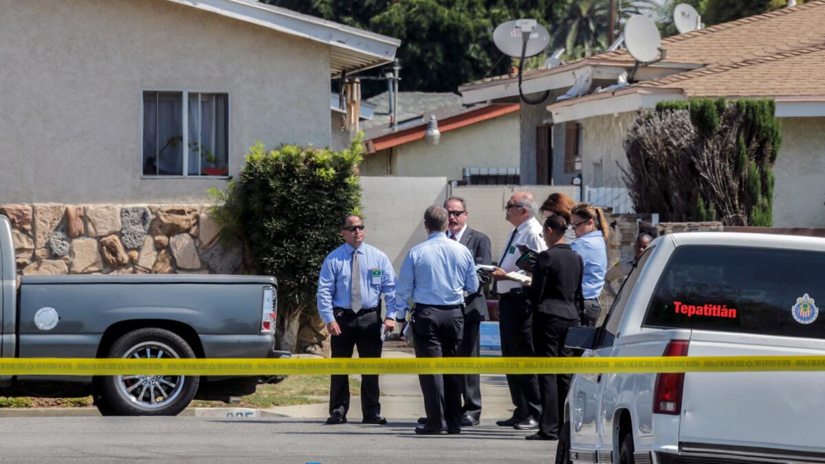 Investigators at the scene on the 800 block of West Stockwell Street where a man was shot by SWAT officers Thursday in Compton.