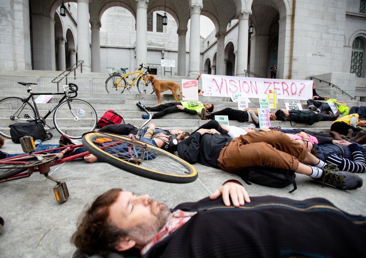 People with bikes lying on the pavement.