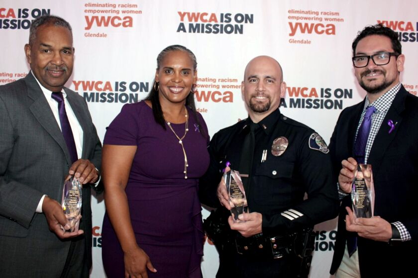 Joining Tara Peterson, YWCA Glendale Executive Director, at the 2019 Purple Tie Awards, are three men noted for their efforts against domestic violence. They are, from left, James Maddox, YWCA volunteer; Sgt. Alex Krikorian, Glendale Police Dept.; and Albert Hernandez, Family Promise of the Verdugos executive director. (Photo by Ruth Sowby Rands)