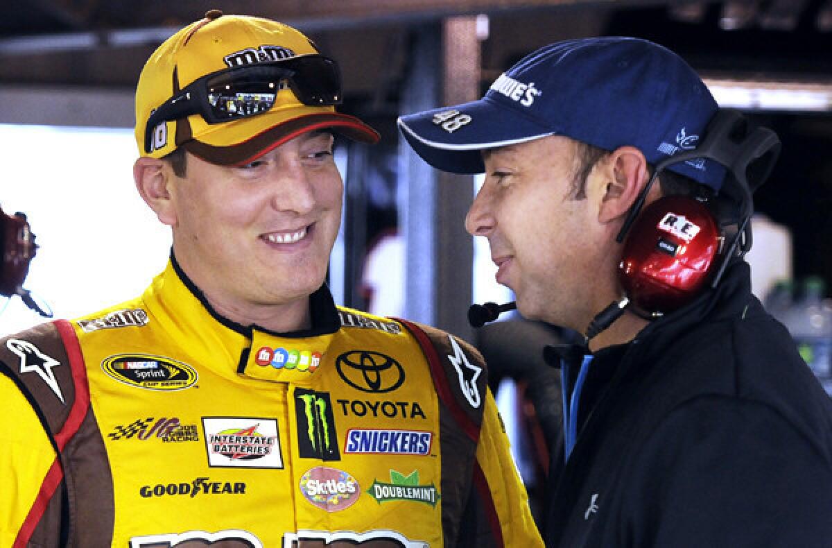 NASCAR driver Kyle Busch, left, talks to Chad Knaus, crew chief for rival Jimmie Johnson, during a practice session at Martinsville Speedway on Friday.
