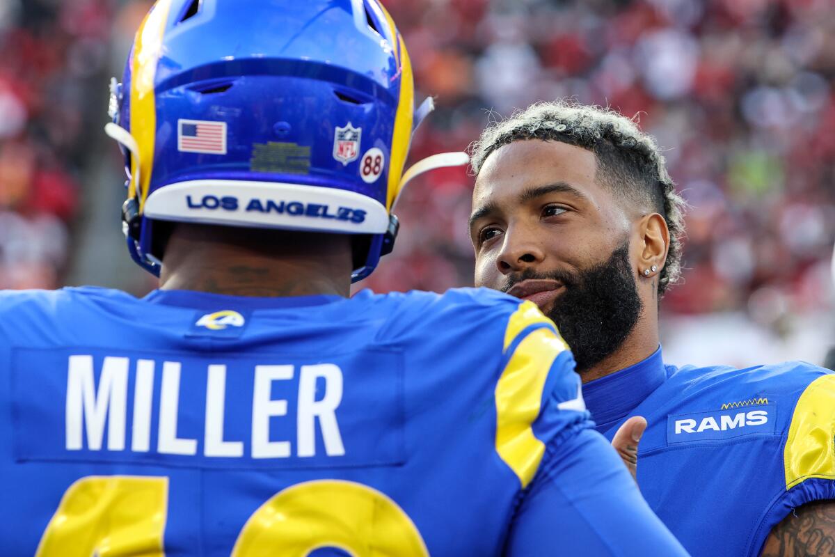 Rams teammates Odell Beckham Jr. (right) and Von Miller share a moment on the sideline.