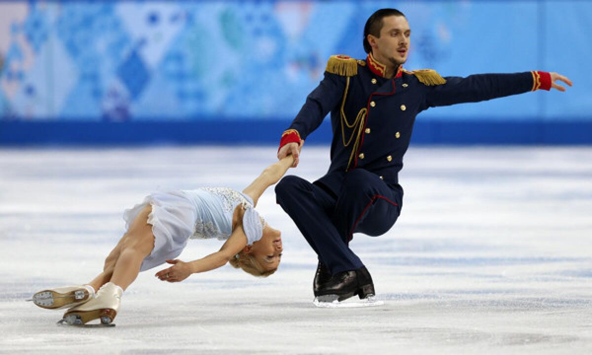 Russia's Maxim Trankov and Tatiana Volosozhar perform their short program during the team figure skating competition in the Sochi Winter Olympics on Thursday. The duo is looking to win gold in the pairs competition after Russia's disappointing performance at the 2010 Vancouver Olympic Games.