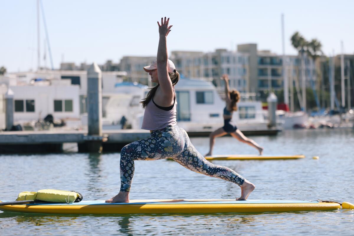 Courtney Regan participates in a yoga class on the water.