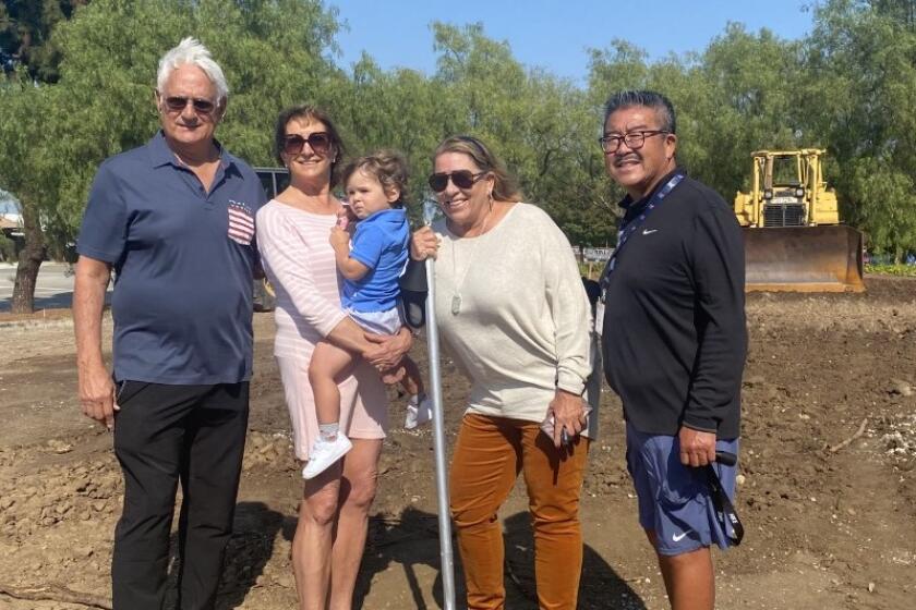 Beach volleyball courts at Rolling Hills Prep. Donors John and Janine Colich (left), coach Anna Collier and AD Harvey Kitani.