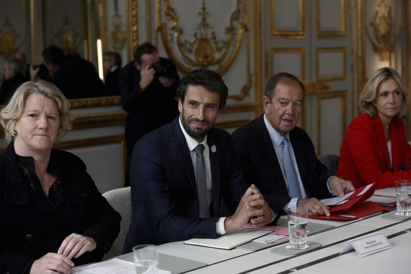 Head of Paris 2024 Olympics Tony Estanguet, center left, President of Greater Paris Metropolis Patrick Ollier, center right, head of the Paris Ile-de-France region, Valerie Pecresse, right, and head of the French National Olympic and Sports Committee (CNOSF), Brigitte Henriques, left, attend a meeting with French President Emmanuel Macron and the Olympics and Paralympics Council, at the Elysee Palace, in Paris, Thursday, Sept. 29, 2022. (Benoit Tessier/ Pool Photo via AP)