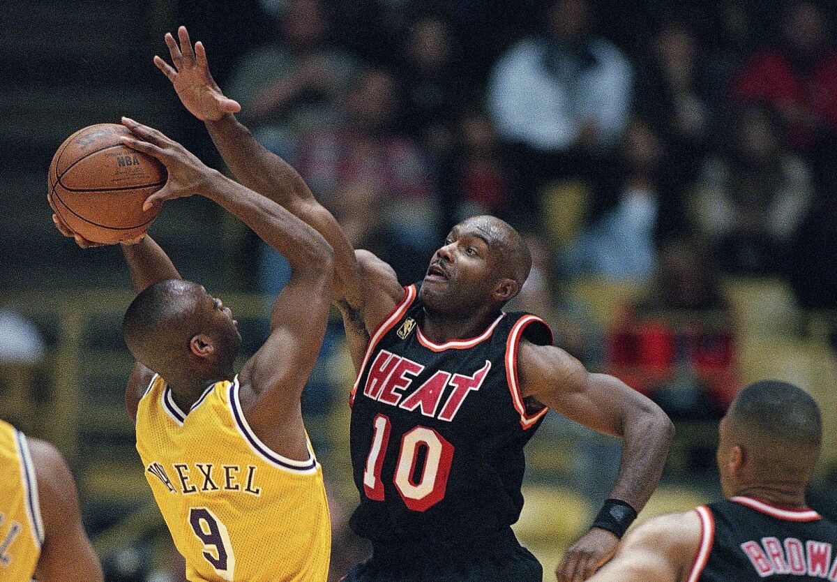 Tim Hardaway tries to block a shot by Lakers guard Nick Van Exel while playing for the Miami Heat.
