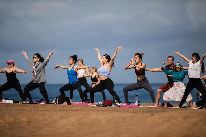 People participate in a yoga class at Sunset Cliffs in Ocean Beach on Sunday, March 6, 2022. Jackie Kowalik, who teaches the yoga class, also offers classes at Civita Park in Mission Valley and the Flower Fields at Carlsbad. More information can be found at yogajawn.com.