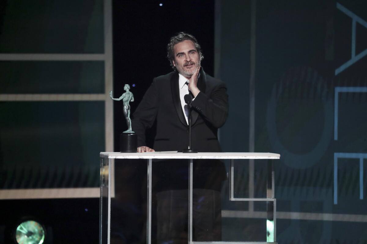 Joaquin Phoenix accepts his SAG Awards trophy. What will he say if he wins the Oscar?