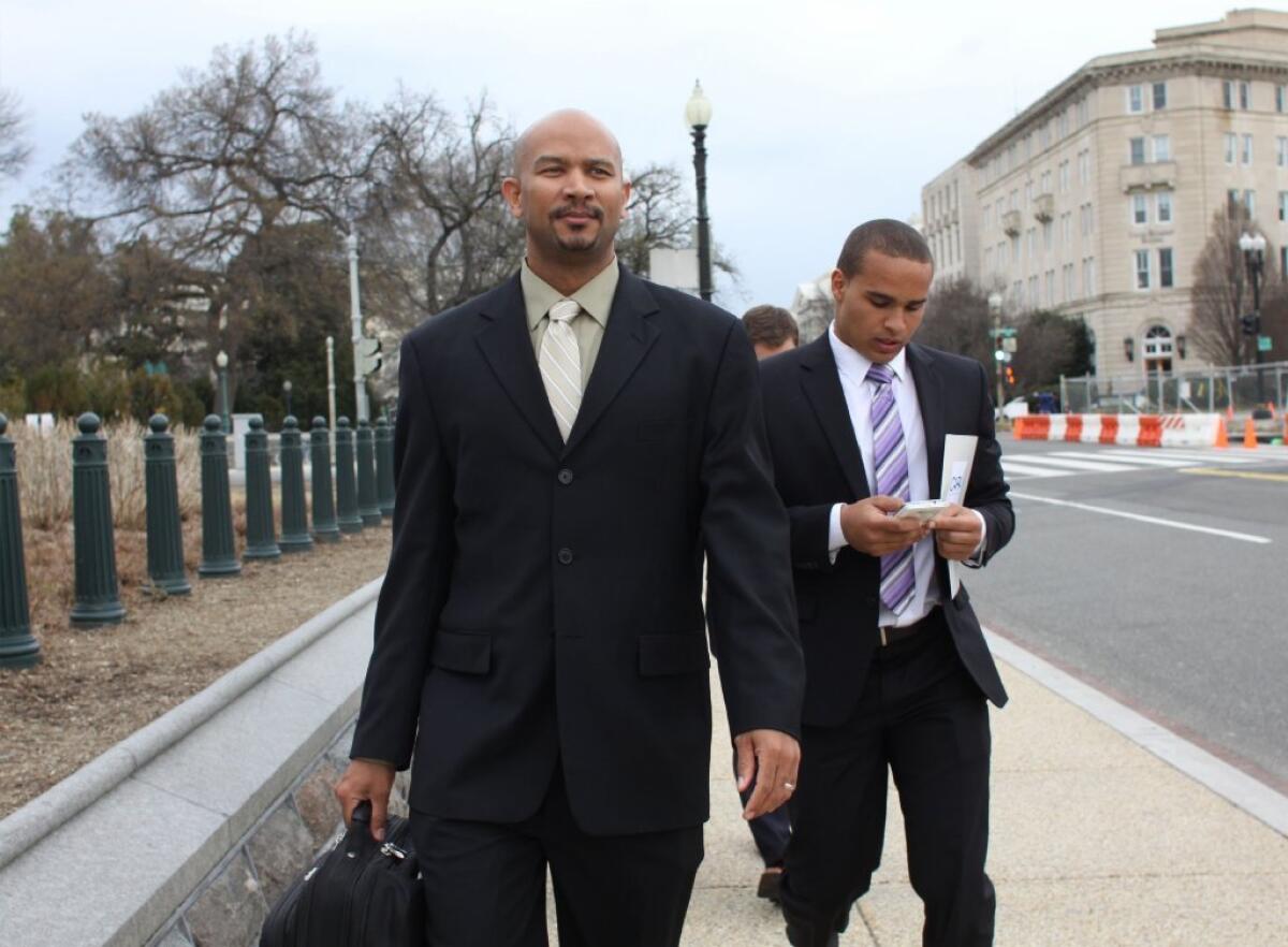 Former Northwestern quarterback Cain Colter, right, and union leader Ramogi Huma arrive on Capitol Hill.