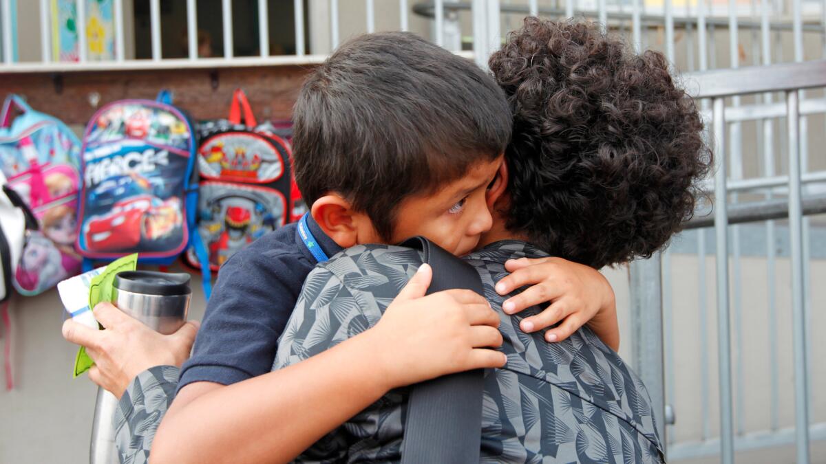 Diego Cassetti-Kheshti, 5, gets one last hug as his mom, Roshanak Kheshti, drops him off for kindergarten at Spreckels Elementary School in University City on August 29, 2016. Few California parents know their rights when it comes to shaping their children's schools.
