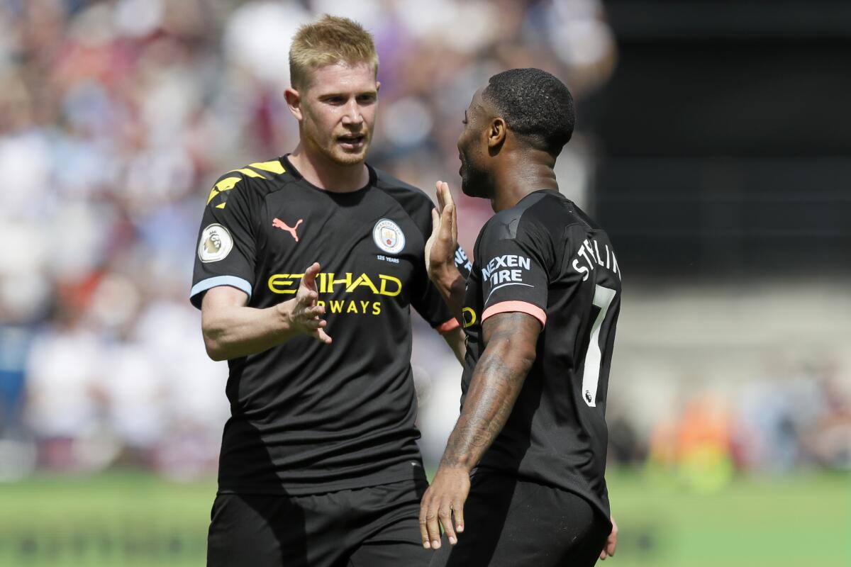 Manchester City's Kevin de Bruyne congratulates Raheem Sterling after a goal against West Ham United on Aug. 10, 2019.
