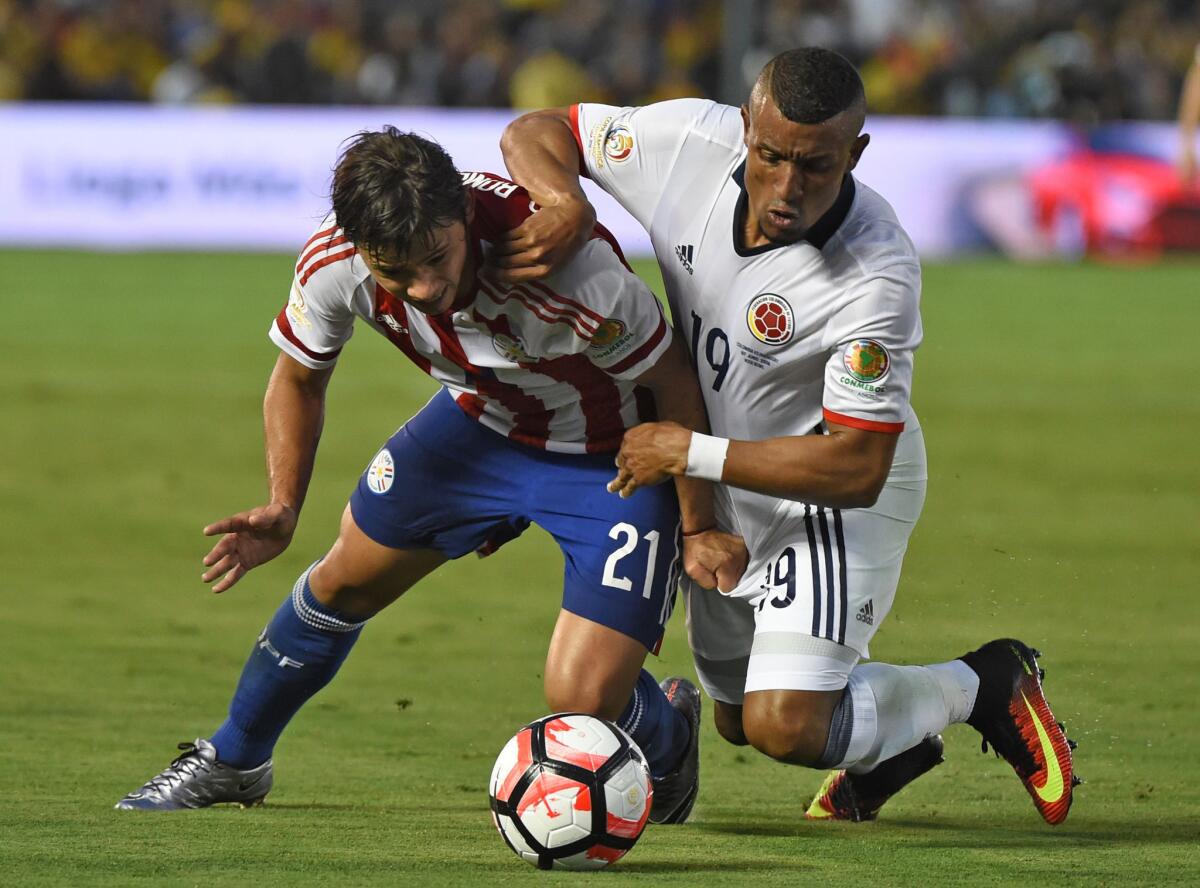 Paraguay's Oscar Romero, left, and Colombia's Farid Diaz vie for the ball during the Copa America Centenario match at the Rose Bowl on June 7.