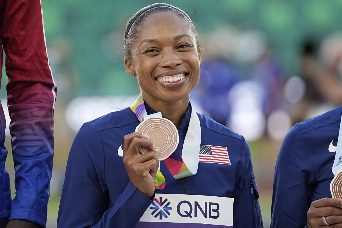 Allyson Felix holds the bronze medal she won as part of the U.S. 4x400 relay team at the world track and field championships.