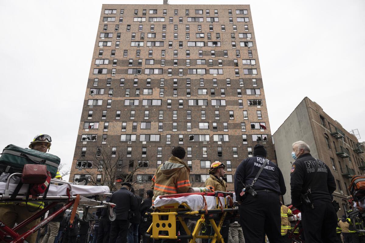 Emergency personnel outside high-rise building hit by fire