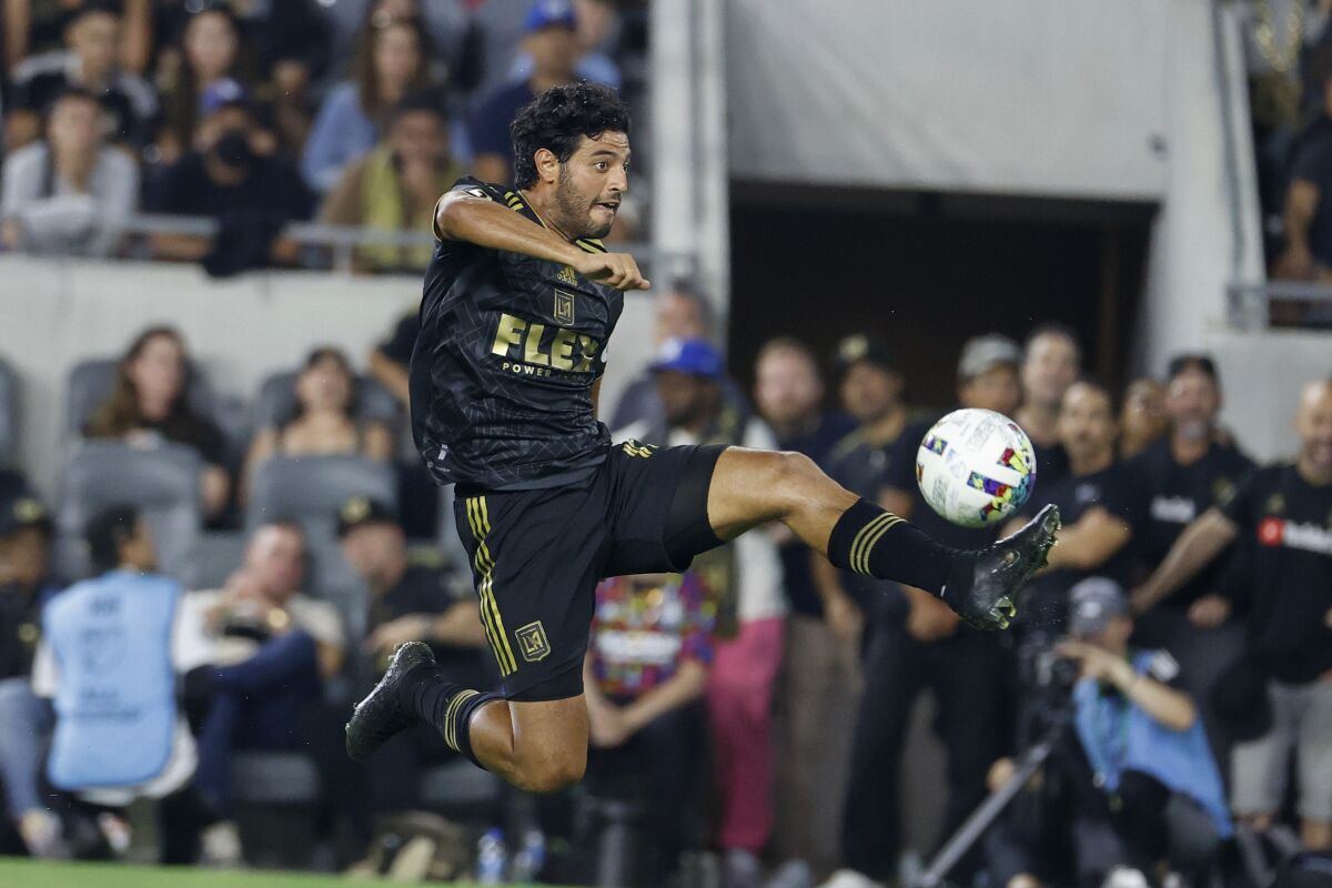 LAFC forward Carlos Vela controls the ball 