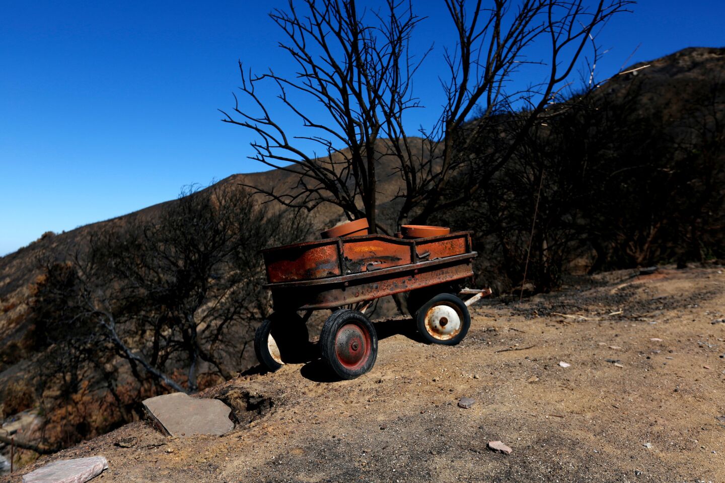 A wagon destroyed by the Soberanes fire rests on Palo Colorado Road in Carmel.
