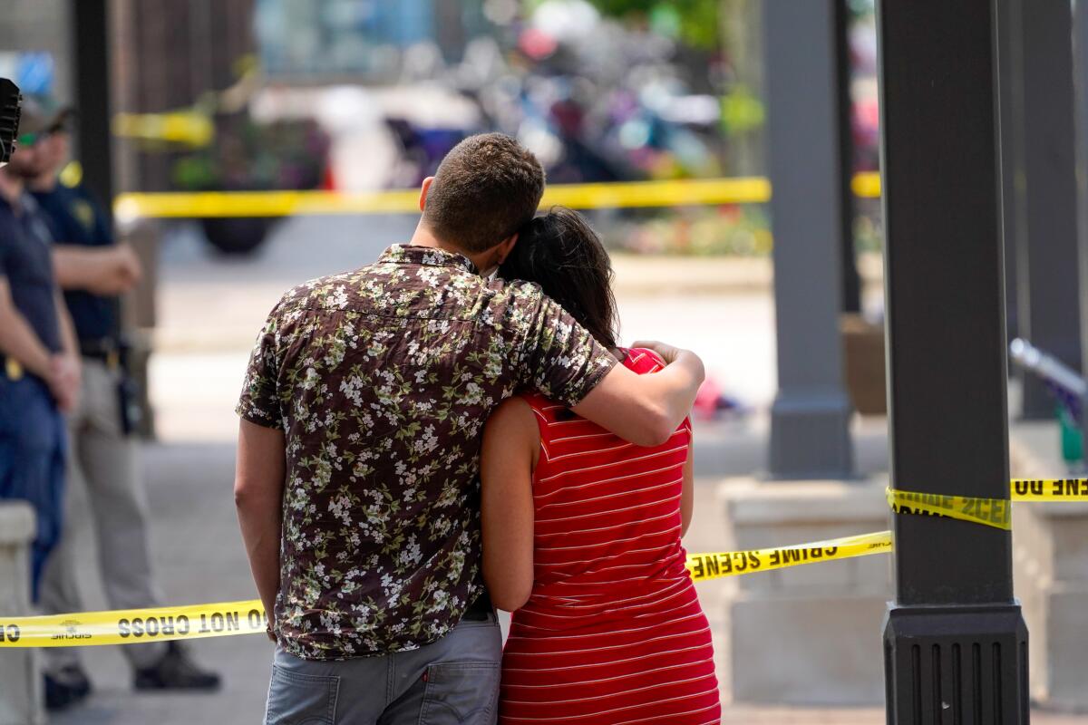 A couple looks toward the scene of the mass shooting