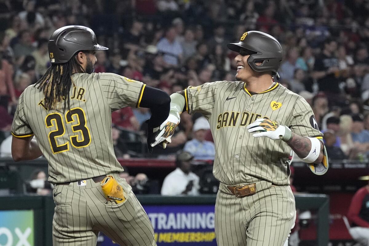 The Padres' Manny Machado celebrates his two-run home run with Fernando Tatis Jr. 