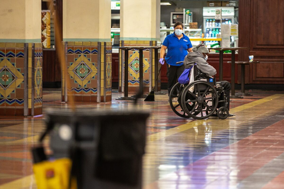 A janitor cleans the food court area in Union Station.