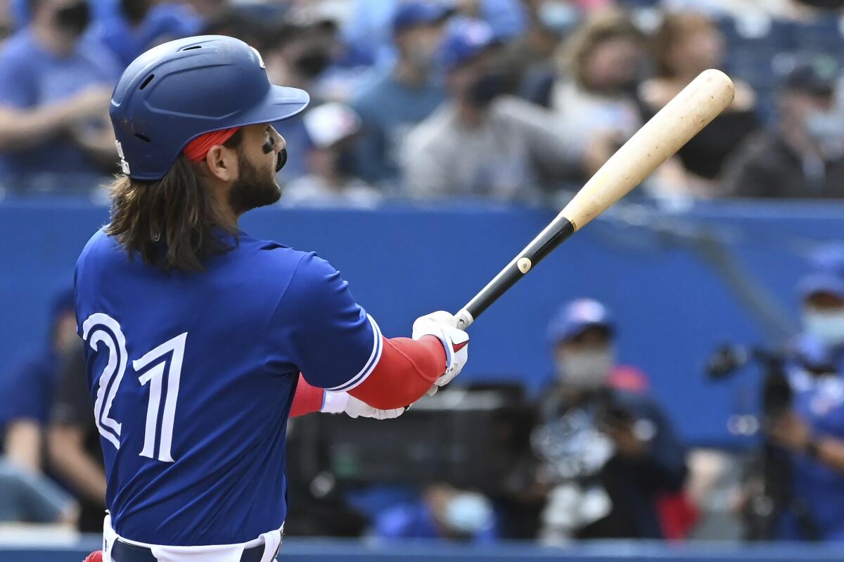Toronto Blue Jays' Bo Bichette watches his three-run home run in the first inning in the first inning of a baseball game against the Tampa Bay Rays in Toronto on Wednesday, Sept. 15, 2021. (Jon Blacker/The Canadian Press via AP)