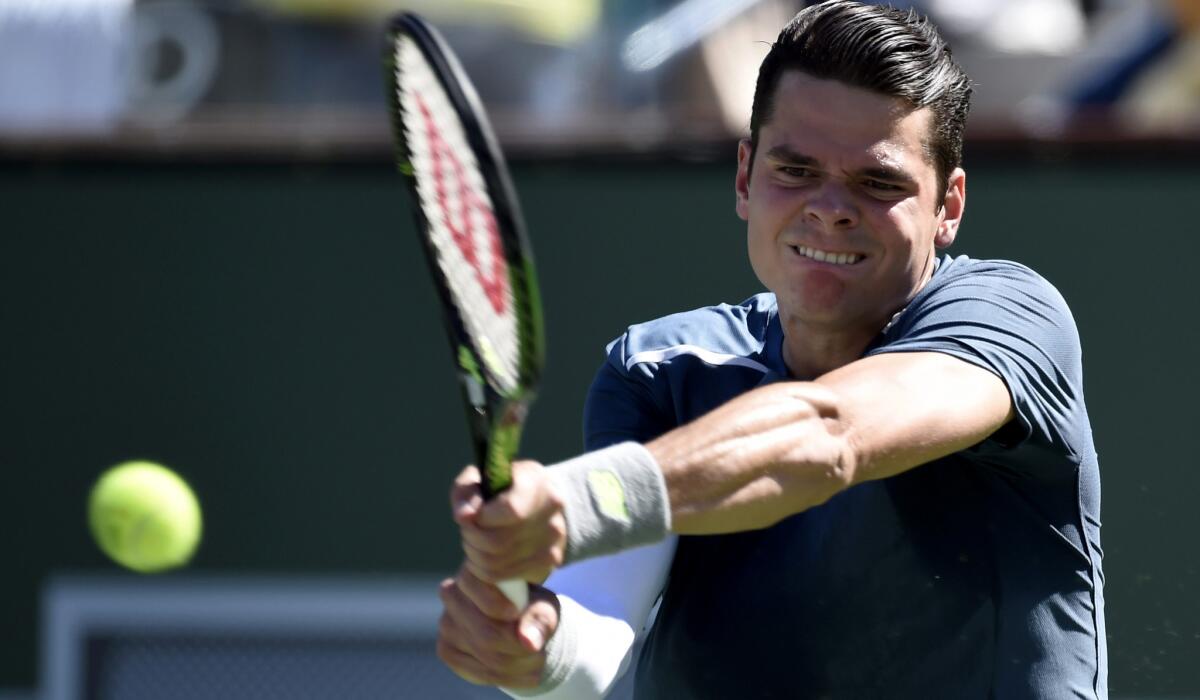 Milos Raonic swats a backhand during his three-set victory over Rafael Nadal on Friday at the Paribas Open.