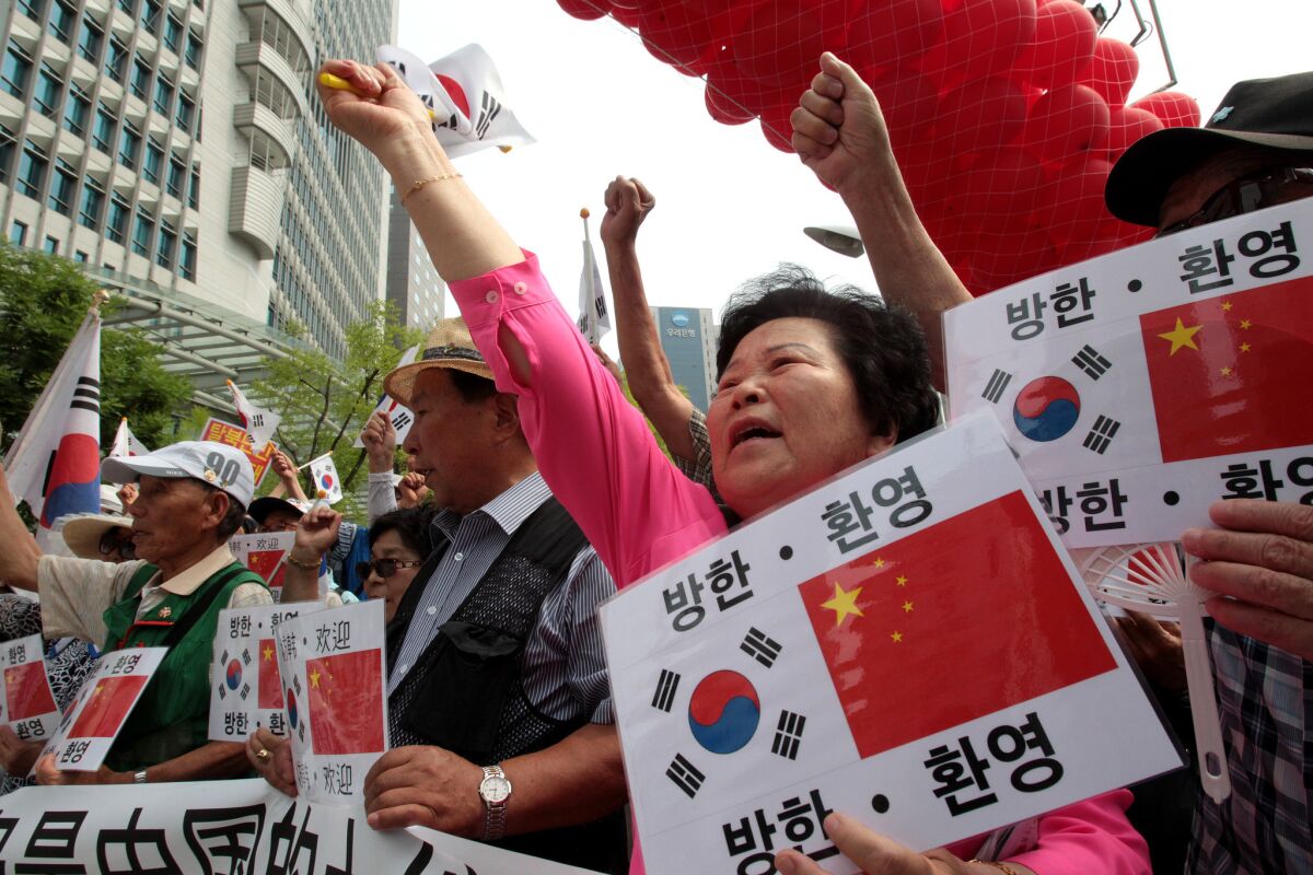 Conservative activists shout during a rally welcoming Chinese President Xi Jinping's visit to South Korea, near the Chinese Embassy in Seoul on Wednesday.