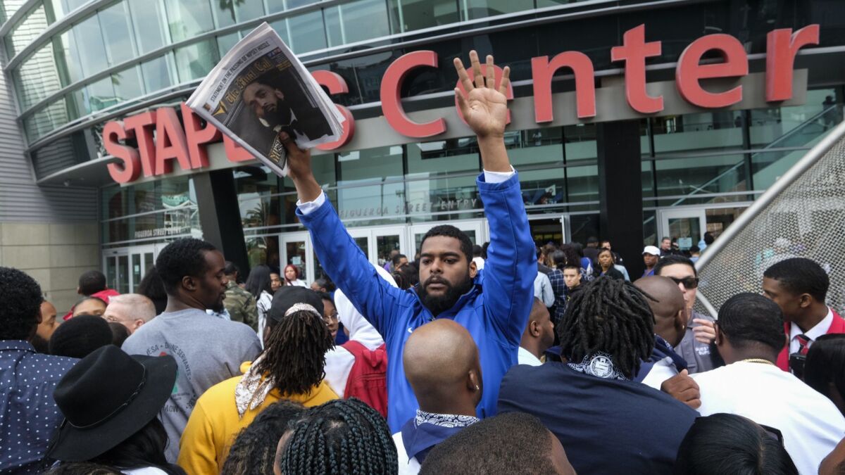 Fans of rapper Nipsey Hussle wait in line Thursday to attend a memorial service at Staples Center in downtown Los Angeles.