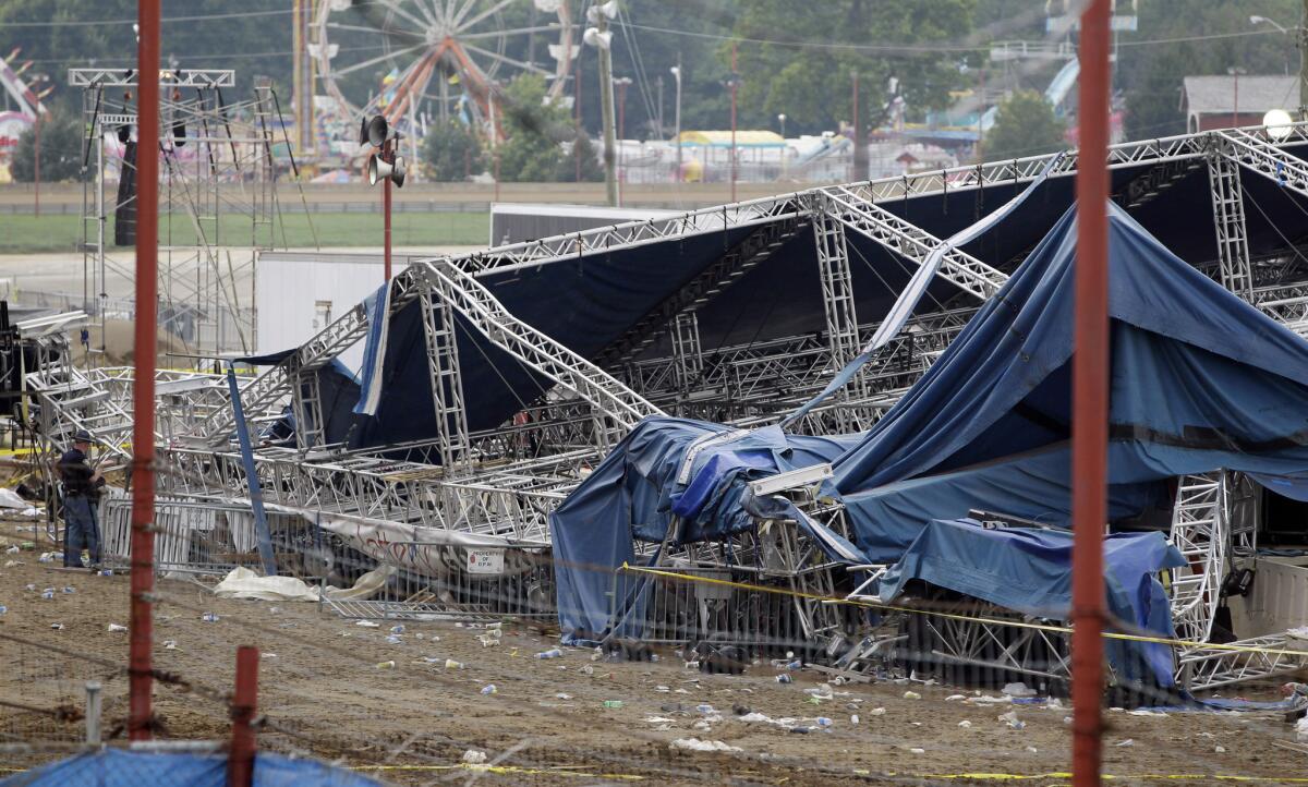 Indiana State Police and authorities survey the collapsed rigging and Sugarland stage on the infield at the Indiana State Fair in Indianapolis on Aug. 14, 2011.
