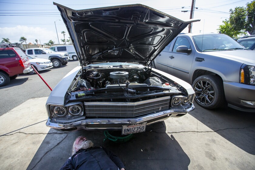 Joe Miracle, 70, works on a 1970 Chevy Impala at his shop, Bay Auto Service in Costa Mesa on Thursday, March 10.