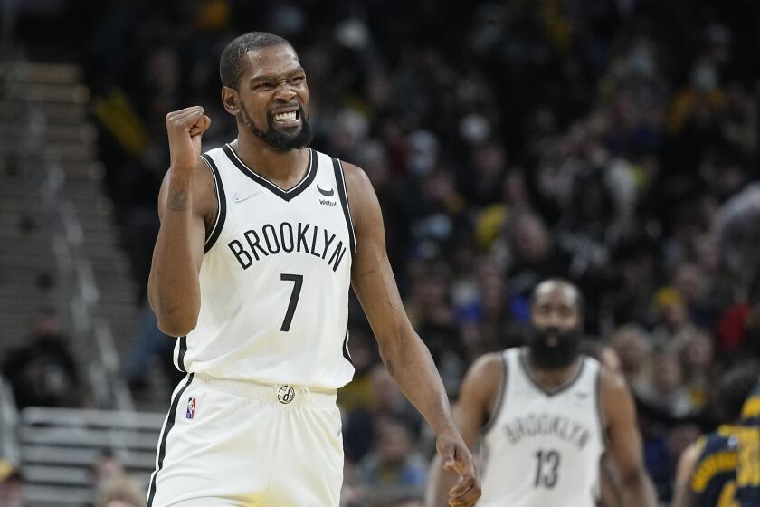 Brooklyn Nets' Kevin Durant shows his teeth and pumps a fist during the second half of a game against the Indiana Pacers