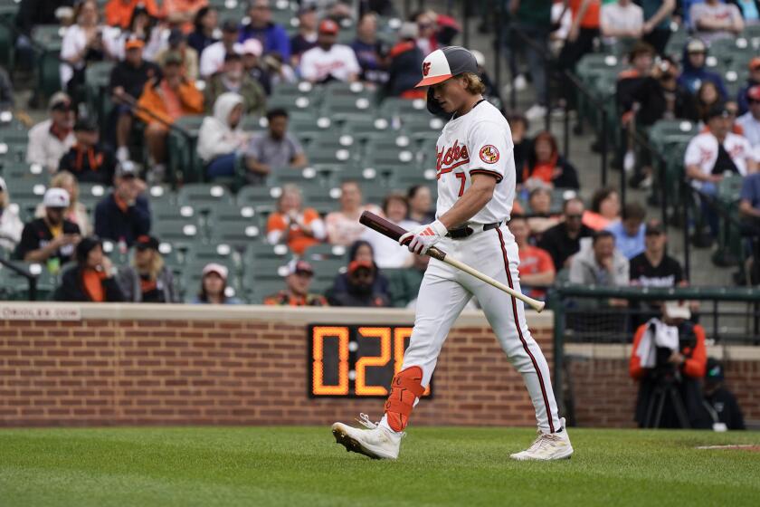 Baltimore Orioles' Jackson Holliday walks to the dugout after striking out against the Minnesota Twins during the sixth inning of a baseball game, Wednesday, April 17, 2024, in Baltimore. (AP Photo/Jess Rapfogel)