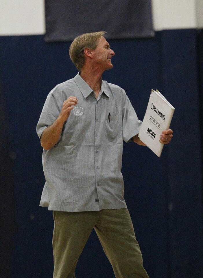Newport Harbor High Coach Dan Glenn grimaces after his team lost a point during the Battle of the Bay girls' volleyball match against Corona del Mar on Saturday.