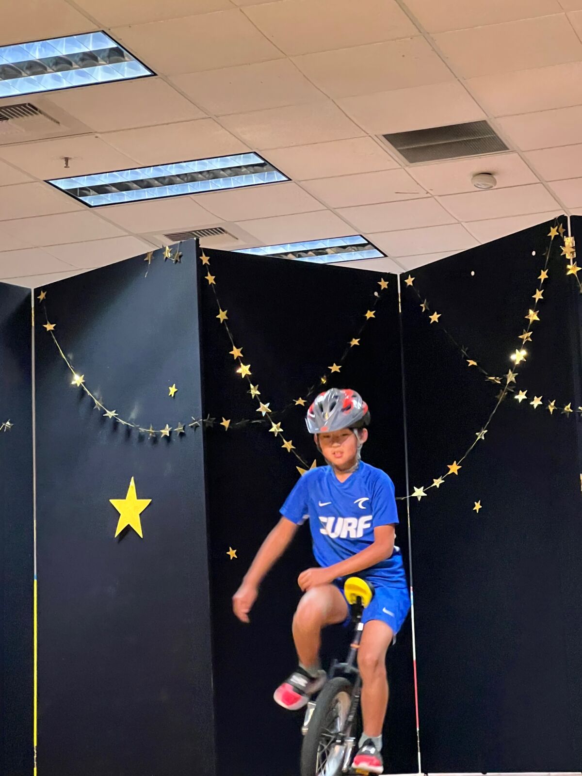 A unicycle rider in the talent show.