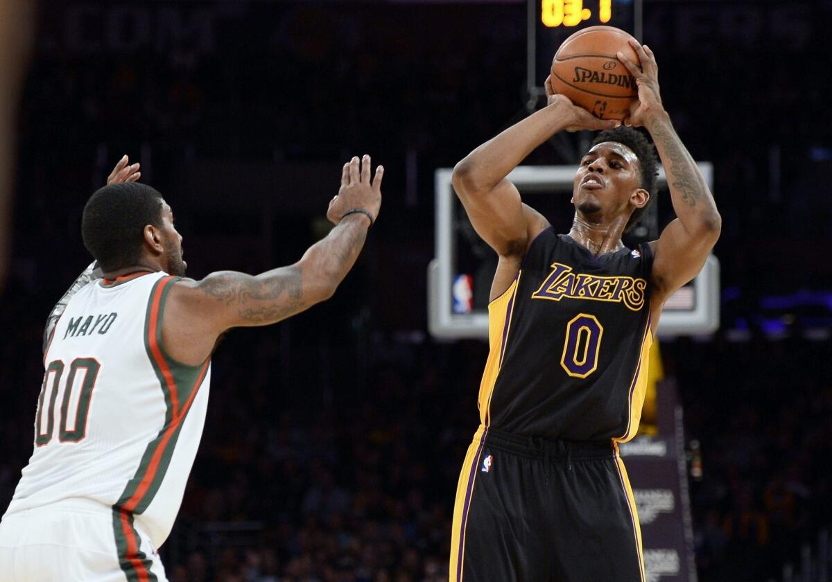 Lakers guard Nick Young pulls up for a shot against Bucks guard O.J. Mayo in the first half.