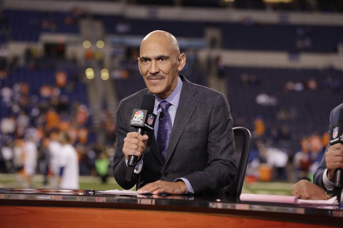 Analyst Tony Dungey speaks on set before an NFL football game.