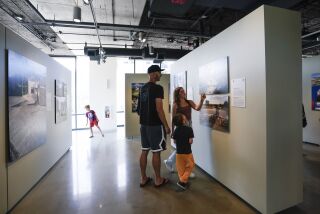 San Diego, CA - May 07: At UC San Diego Park & Market on Saturday, May 7, 2022 in downtown San Diego, CA., Bryan Daniels and his children, Ashlan, Joseph and Grant enjoyed one of the galleries in the second floor. (Nelvin C. Cepeda / The San Diego Union-Tribune)