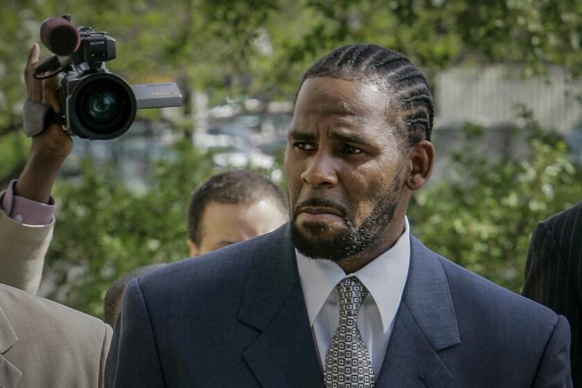 FILE - This photo from Friday May 9, 2008, shows R. Kelly arriving for the first day of jury selection in his child pornography trial at the Cook County Criminal Courthouse in Chicago. On Wednesday, Sept. 15, 2021, prosecutors in Kelly's sex trafficking trial at Brooklyn Federal Court in New York, played video and audio recordings for the jury they say back up allegations he abused women and girls. (AP Photo/Charles Rex Arbogast, File)