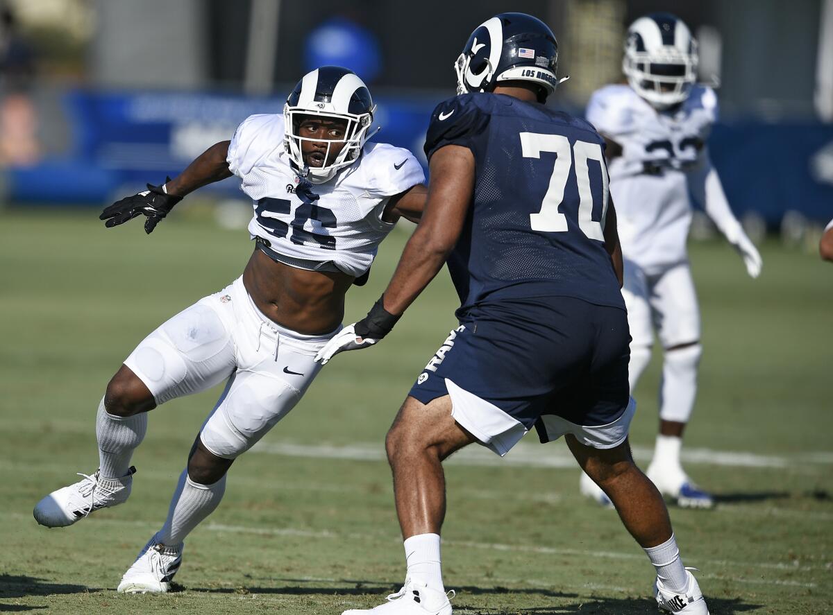 Los Angeles Rams defensive end Dante Fowler, left, rushes against offensive tackle Joe Noteboom during training camp in Irvine.