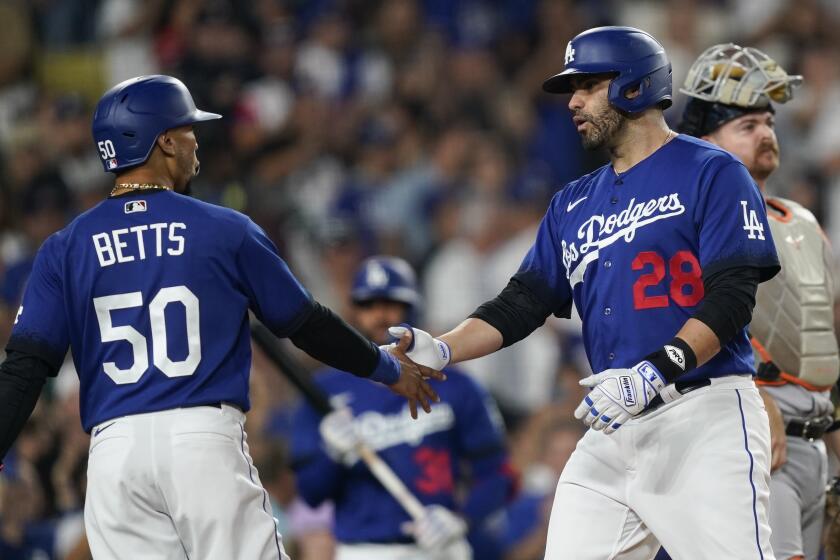 Los Angeles Dodgers designated hitter J.D. Martinez (28) celebrates after his three-run home run.