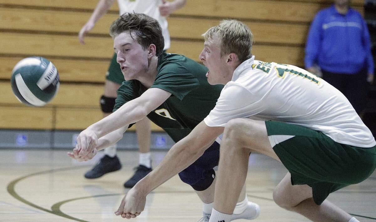 Edison's Owen Shaff, left, and Sam Warren drop to the floor to keep a Laguna Beach serve in play in a pool-play match of the Orange County Championships on Friday.