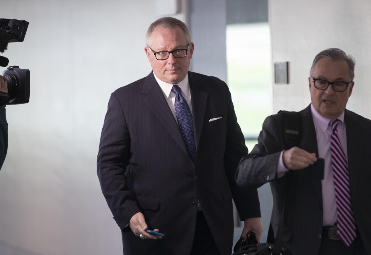 Michael Caputo, left, and his attorney leave an interview with Senate  Intelligence Committee staff in 2018