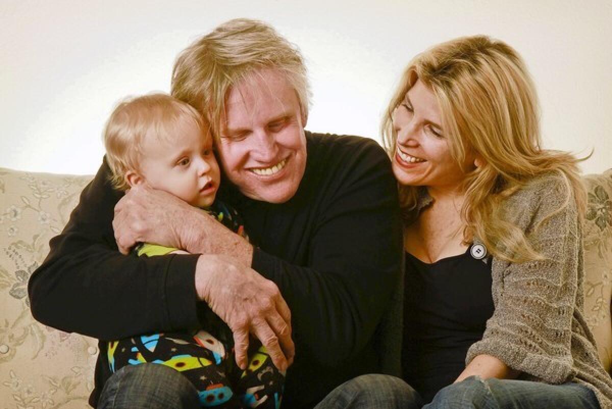 HOMEBODY: "I didn't know how to handle everything that came at me," says actor Gary Busey, hugging son Luke as fiancEe Steffanie Sampson watches.