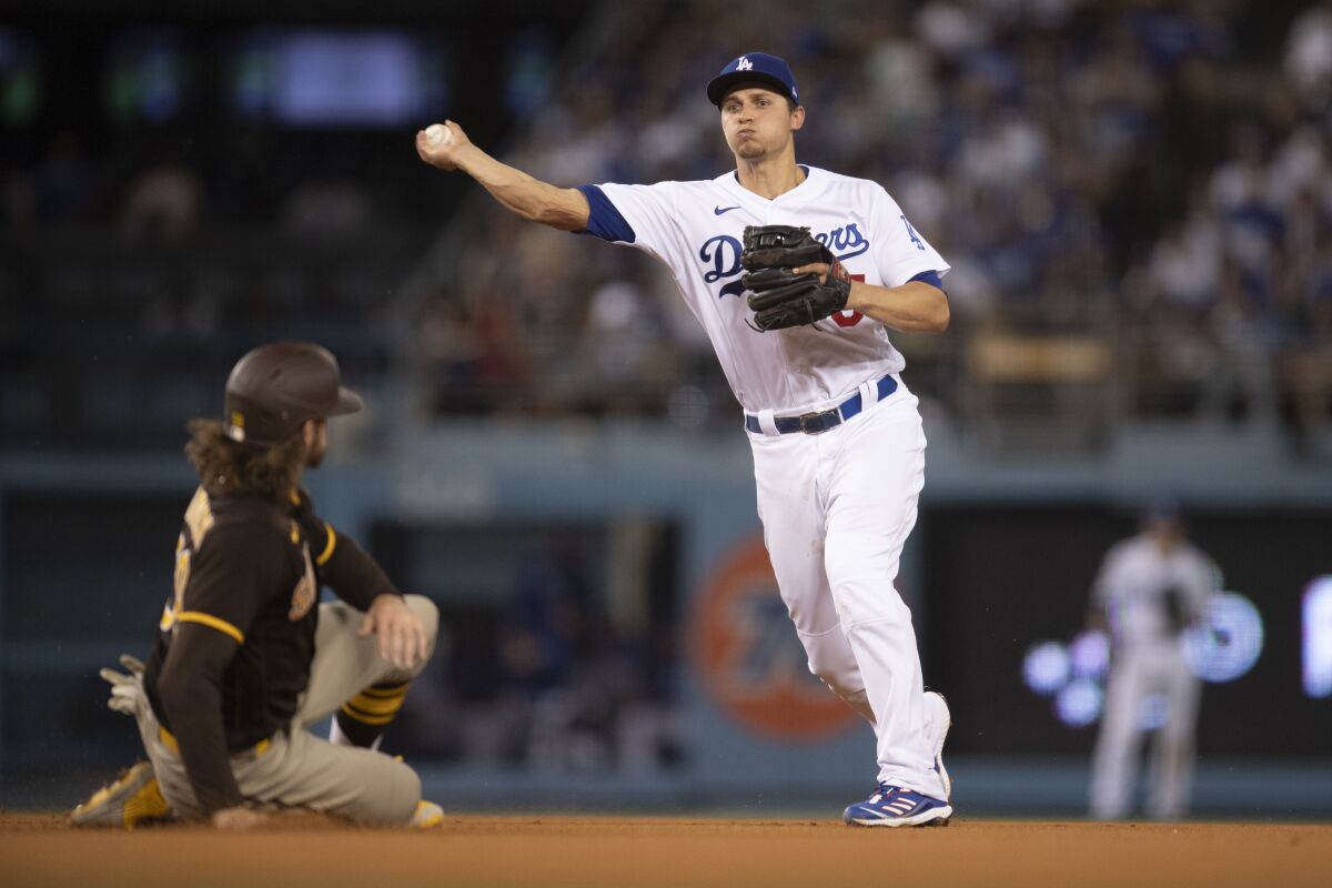 Dodgers shortstop Corey Seager throws after forcing out San Diego's Chris Paddack at second during the fifth inning.