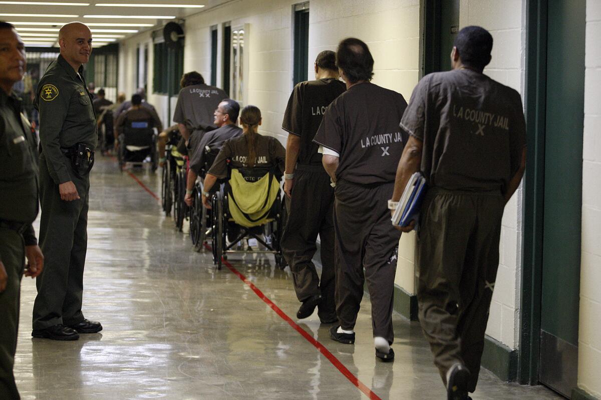 Los Angeles County sheriff's deputies watch inmates at Men's Central Jail in 2012.