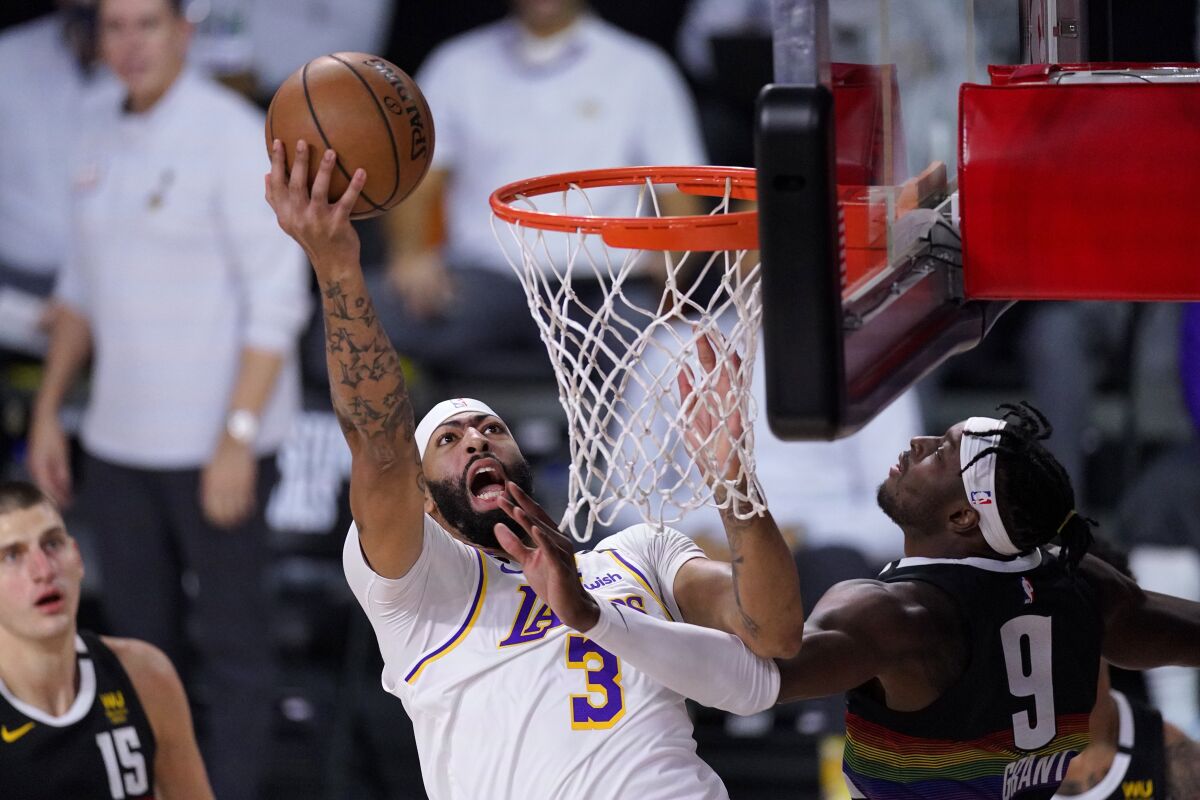 Lakers forward Anthony Davis goes up for a shot against Nuggets forward Jerami Grant during Game 3.