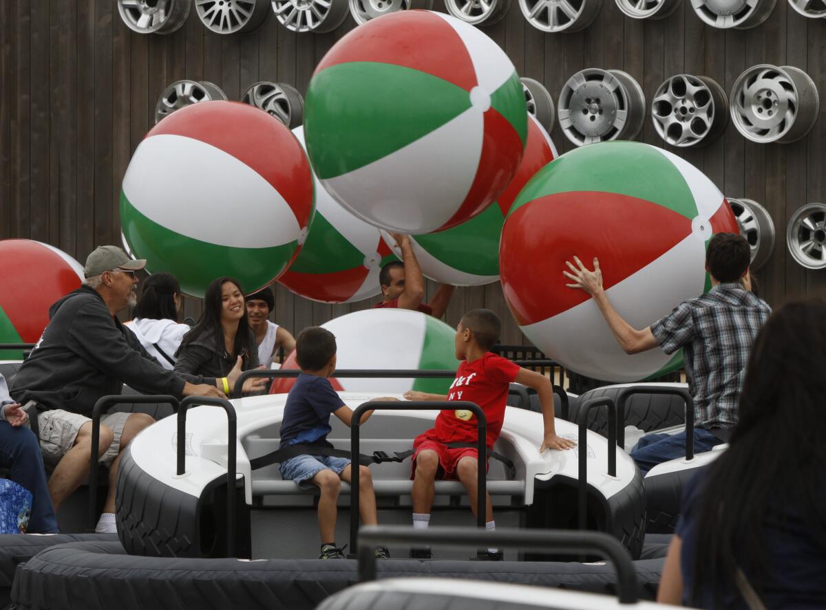 Visitors toss beach balls into the air while they float on a cushion of air at Luigi's Flying Tires during the Cars Land debut to the public at the Disney California Adventure on June 15, 2012. The ride was closed in February 2015.